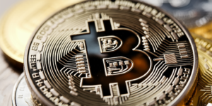 Bitcoin Regains Footing Near $98,000 as Liquidations Close in on $500M